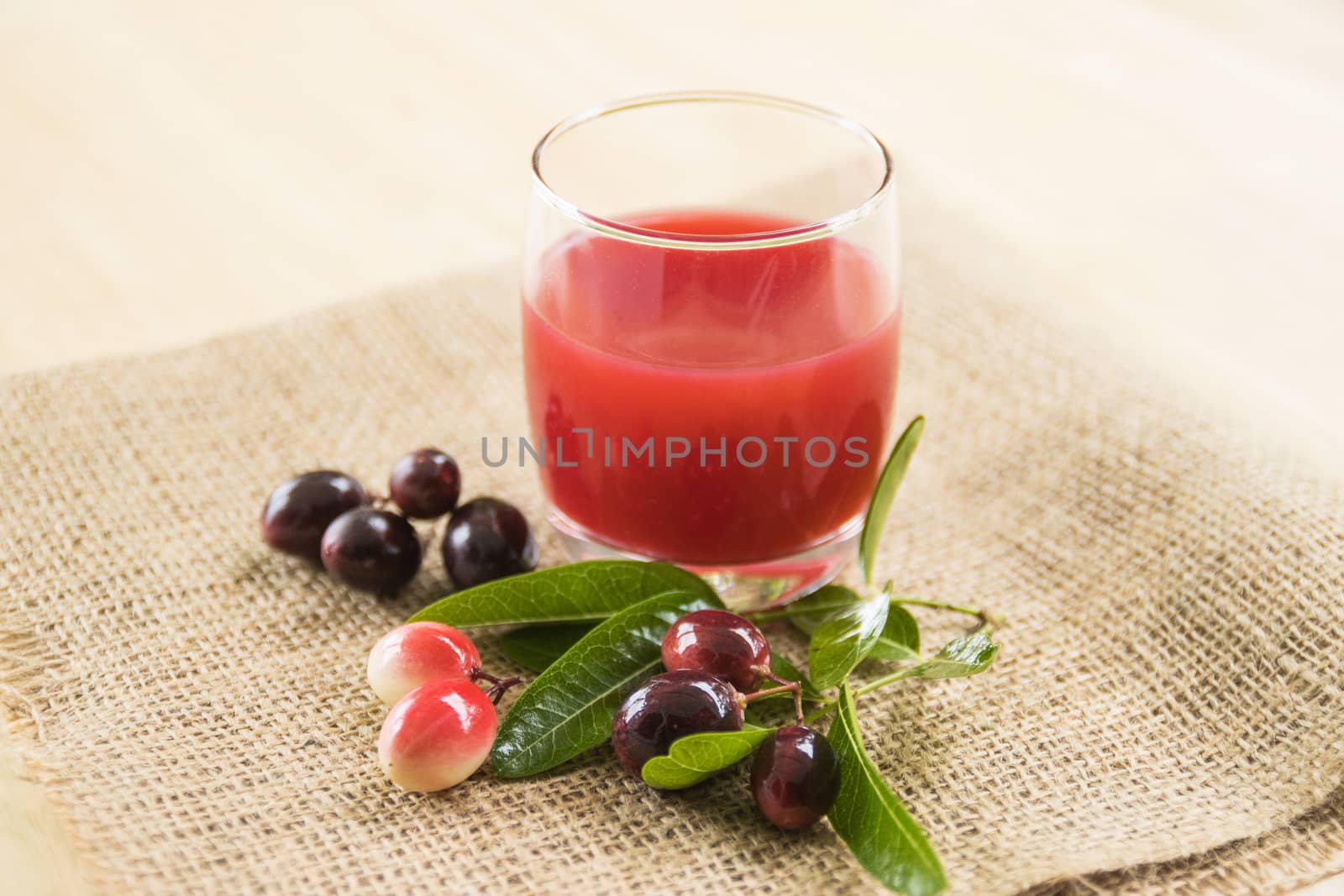 fresh Carissa carandas glass of juice with Carissa carandas fruits and Healthy drinks concept
