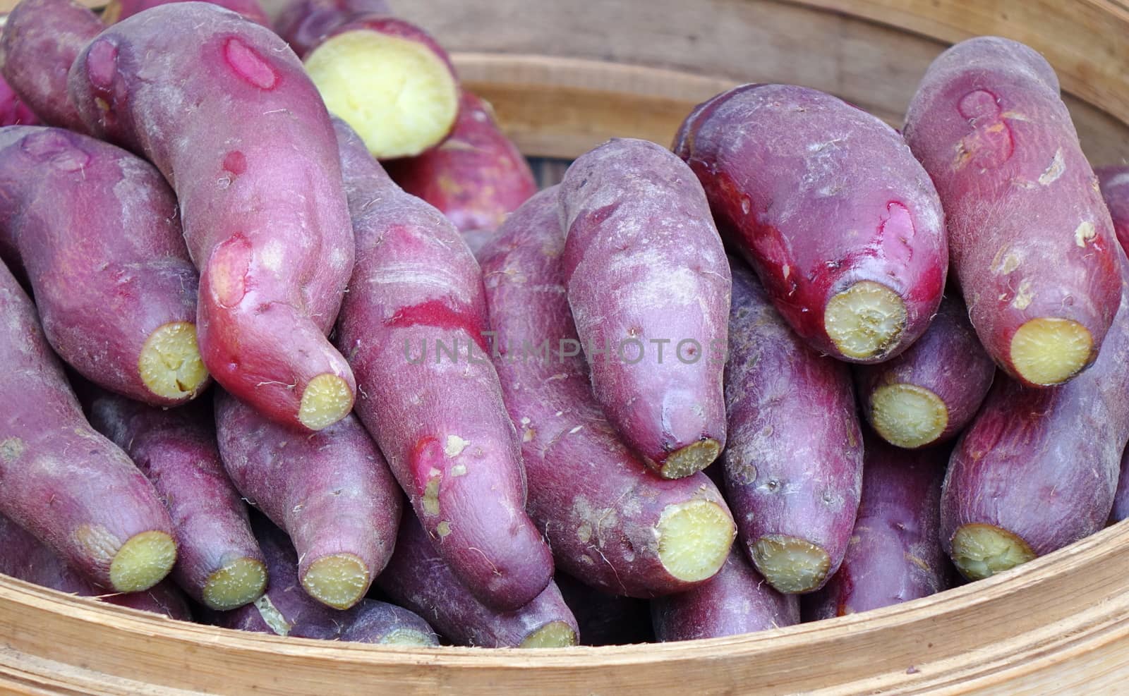 A street vendor sells steamed yams and sweet potatoes