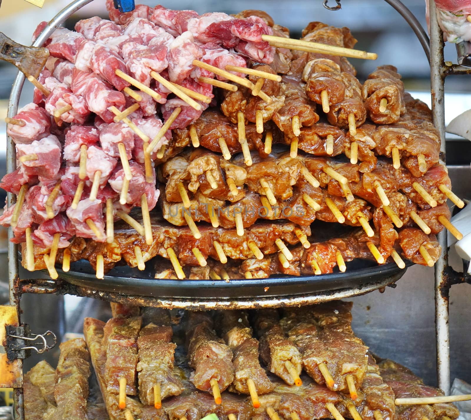 A street food stall in Taiwan offers a variety of meat skewers