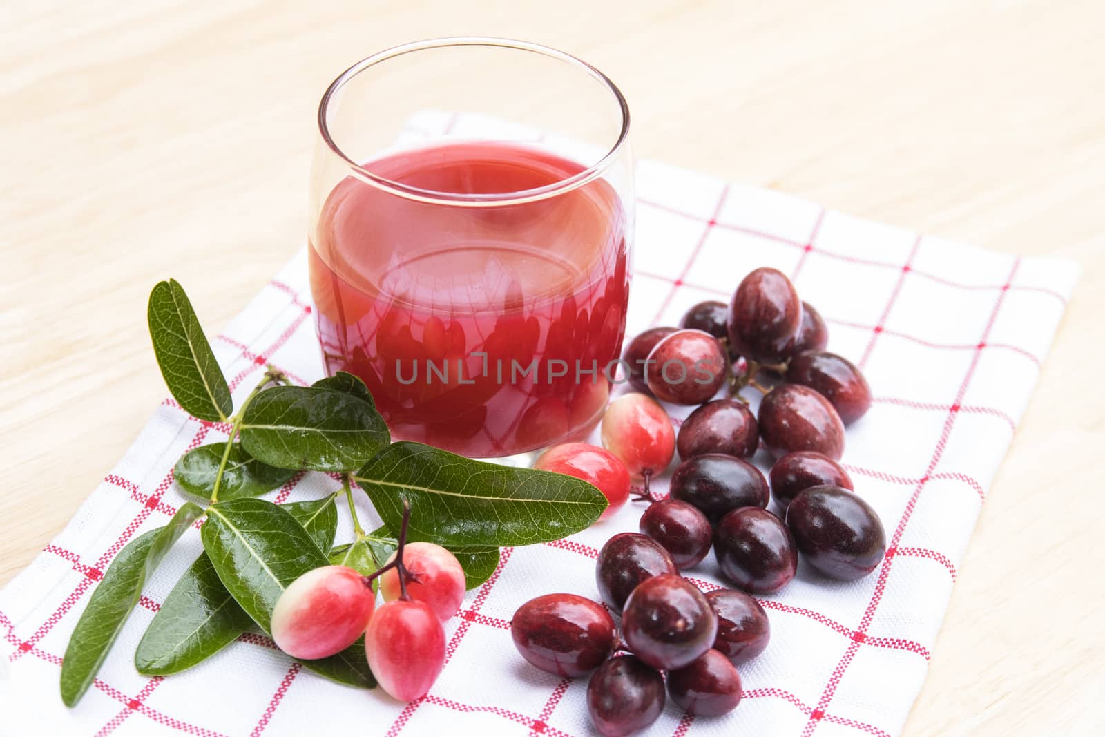 fresh Carissa carandas glass of juice with Carissa carandas fruits and Healthy drinks concept
