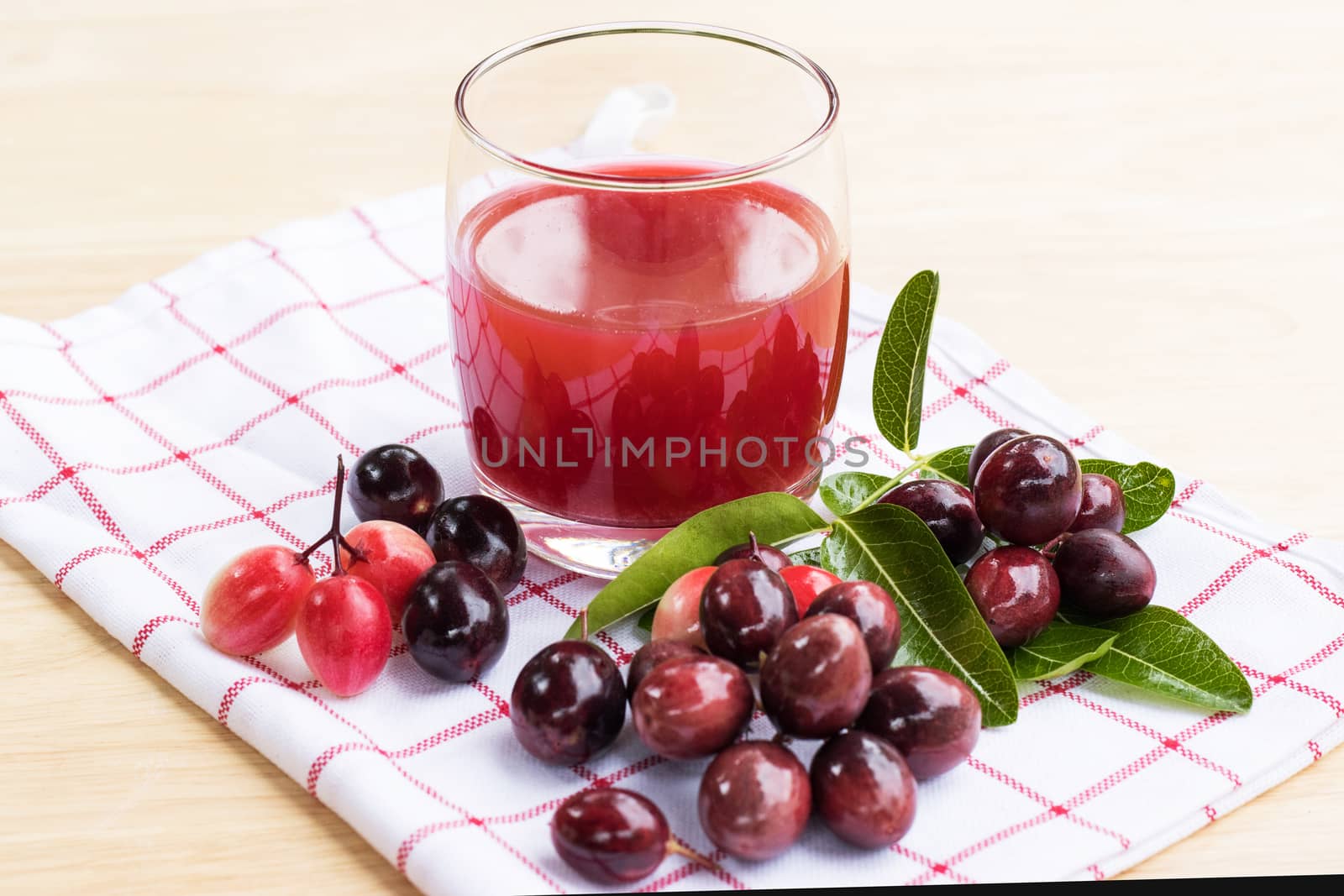 fresh Carissa carandas glass of juice with Carissa carandas fruits and Healthy drinks concept

