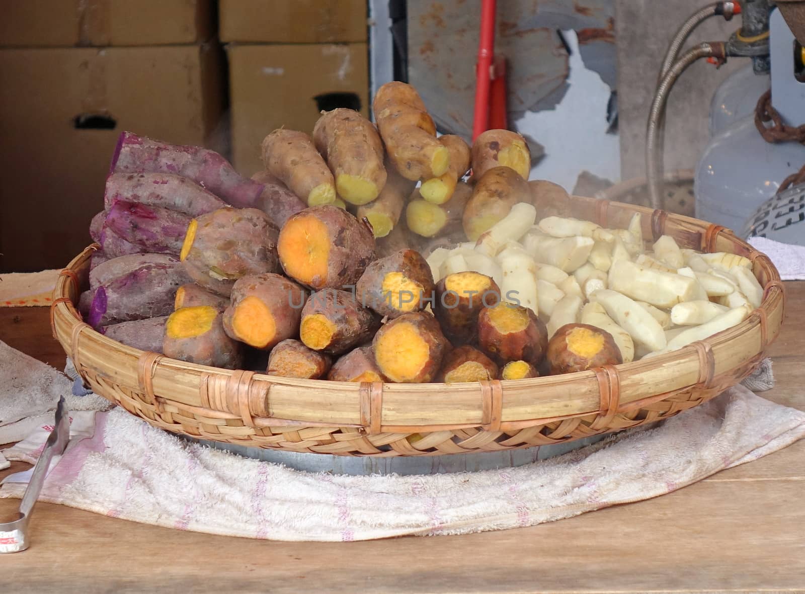 A street vendor sells steamed yams and sweet potatoes
