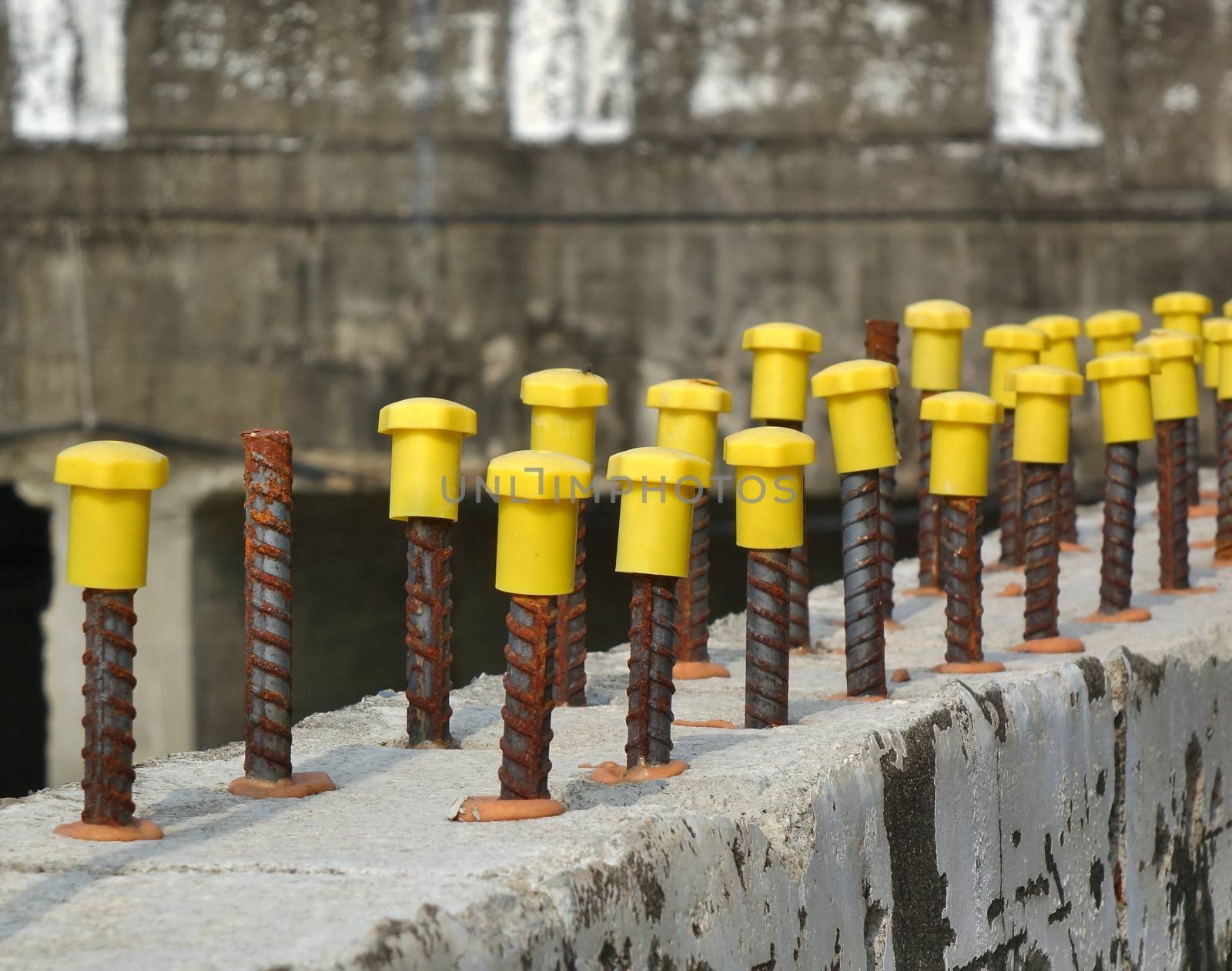 Rebar steel rods with yellow end protection caps
