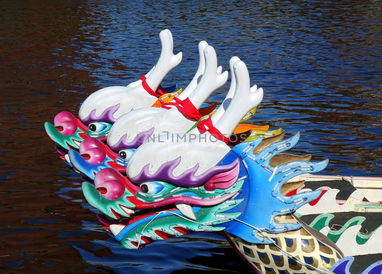 Three dragon boats with the traditional figurehead in the shape of a dragon