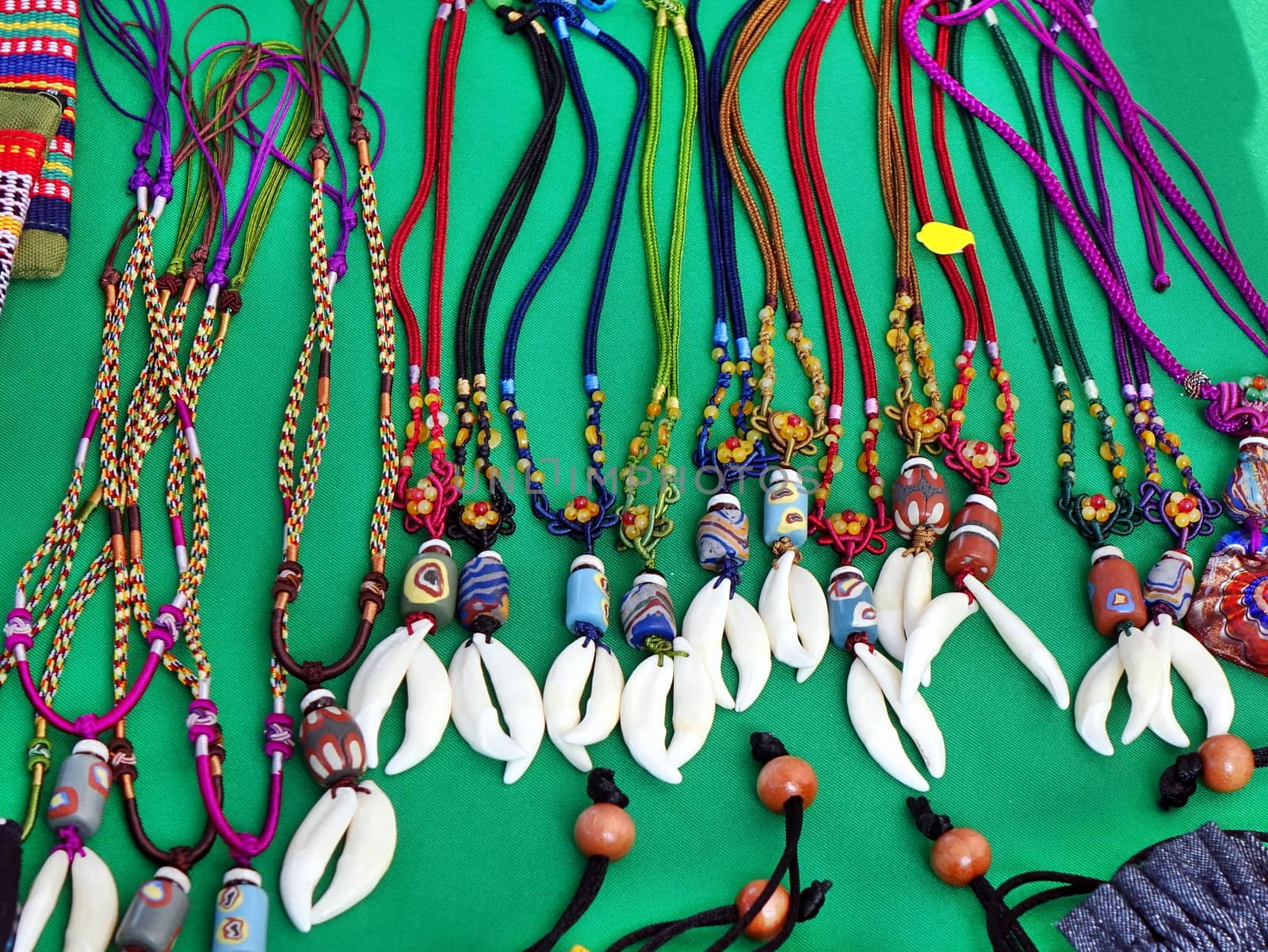 Aboriginal handmade jewelry and necklaces with colorful glass beads and animal teeth for sale at a market