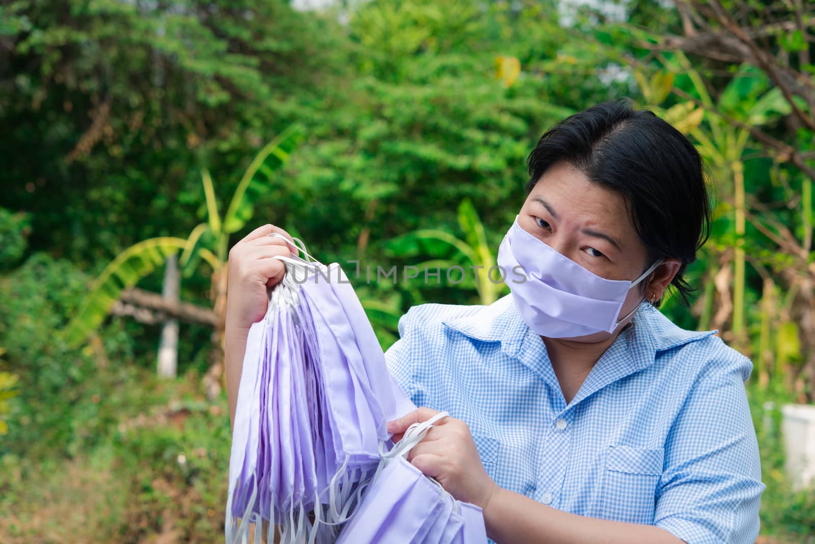 Asian pretty woman wearing mask respiratory protection mask against epidemic flu covid19 or corona virus influenza in office with fear emotion in concept illness, outbreak, healthcare in life