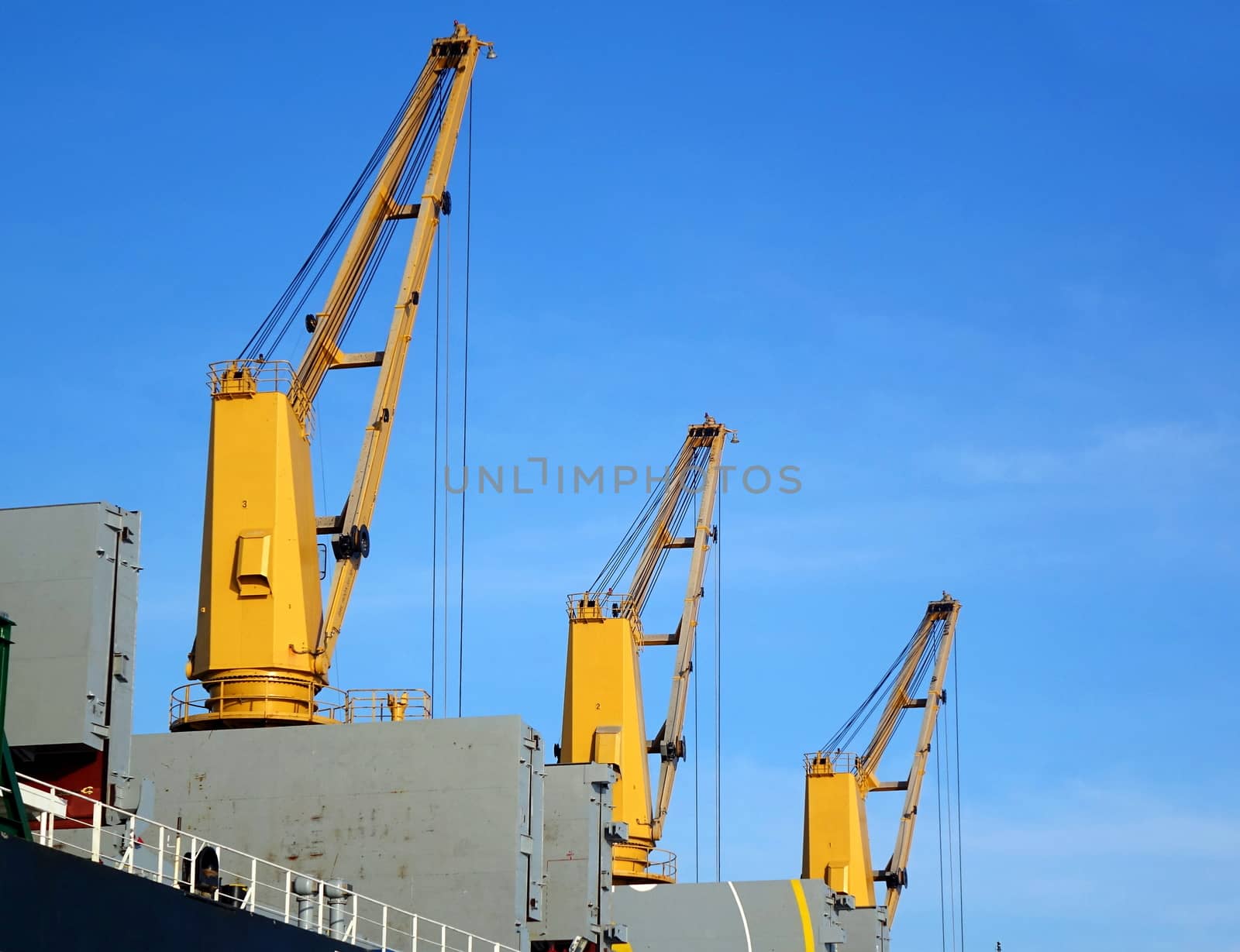 A large ocean-going freight ship with loading cranes

