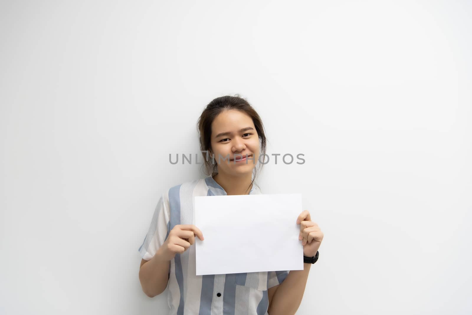 Asian pretty woman showing blank white paper for copy space and message with happy and smile in concept business woman and advertising