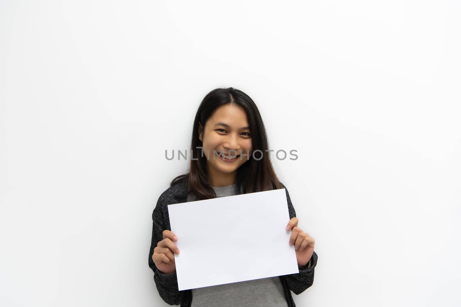 Asian pretty woman showing blank white paper for copy space and message with happy and smile in concept business woman and advertising