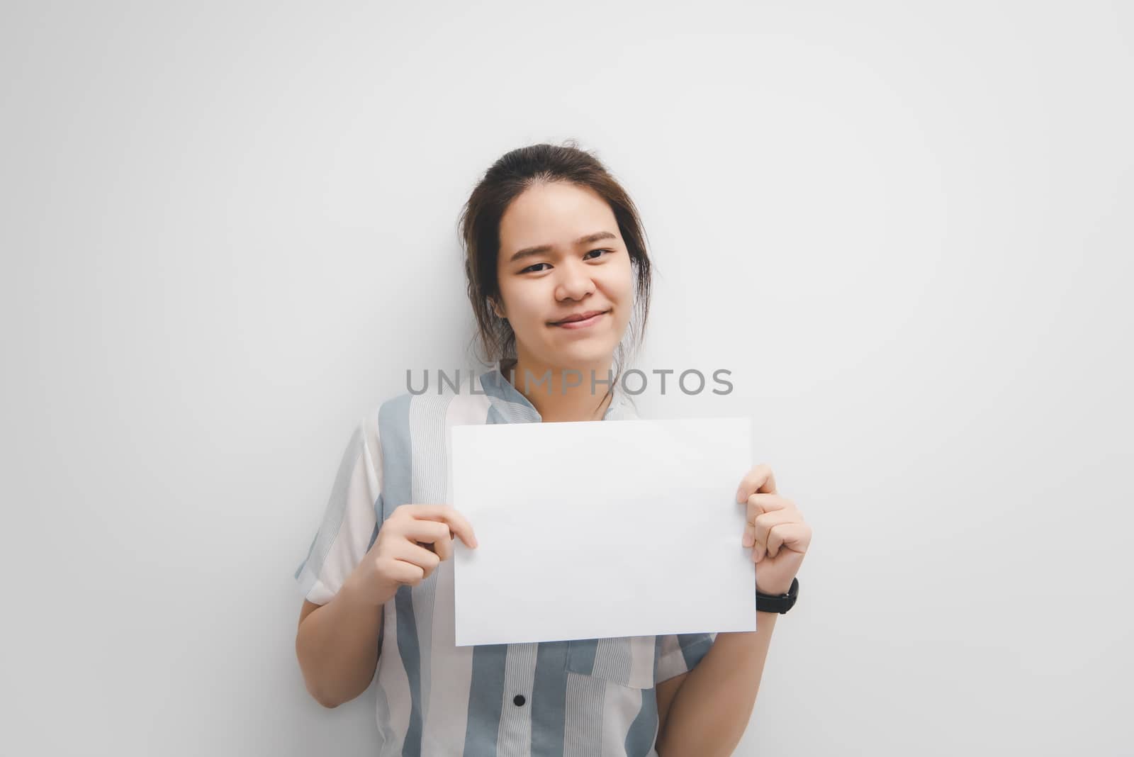 Asian pretty woman showing blank white paper for copy space and message with happy and smile in concept business woman and advertising