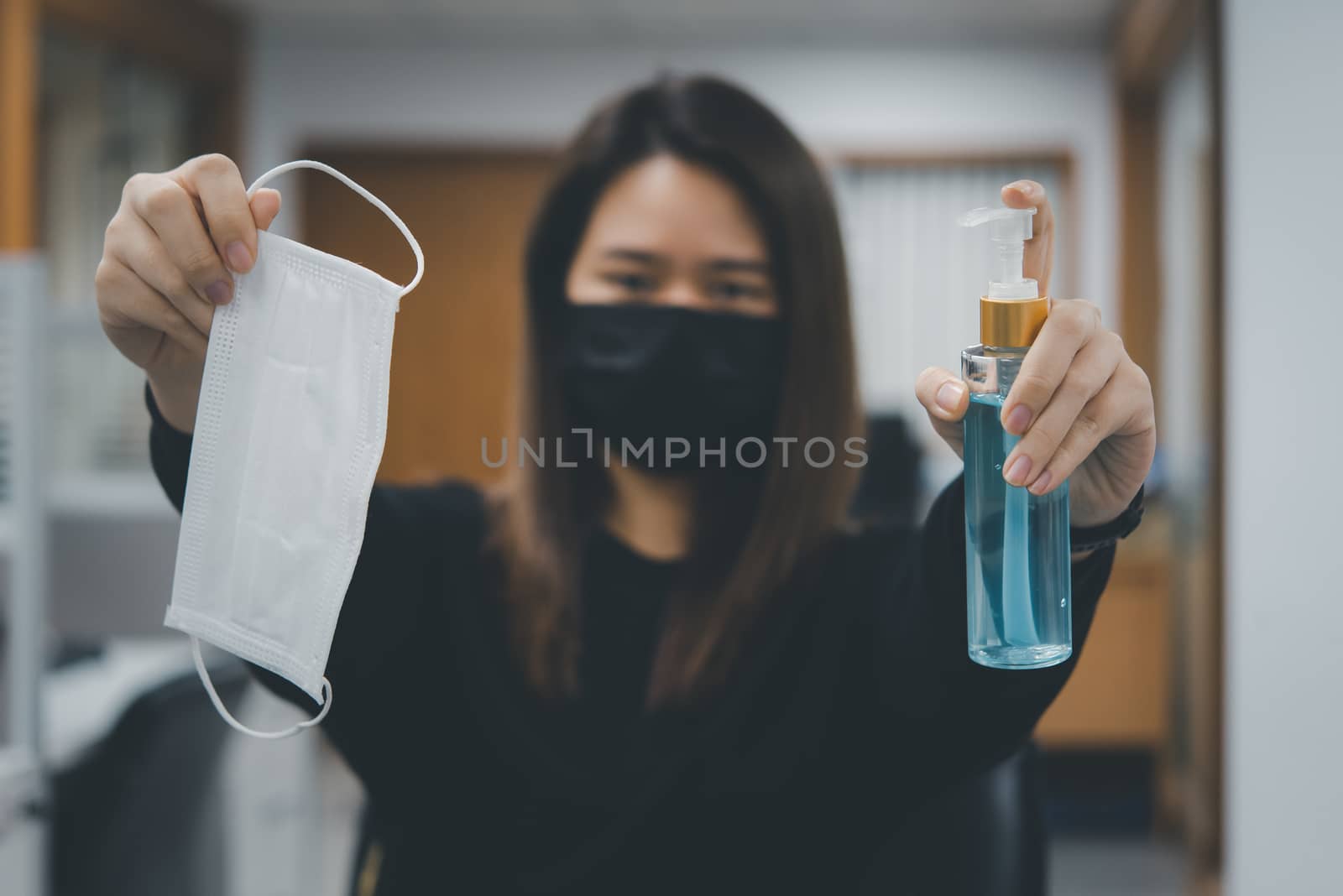 Asian woman wearing mask and alcohol antibacterial hand gel respiratory protection mask against epidemic flu covid19 or corona virus with fear emotion in concept illness, outbreak, healthcare in life