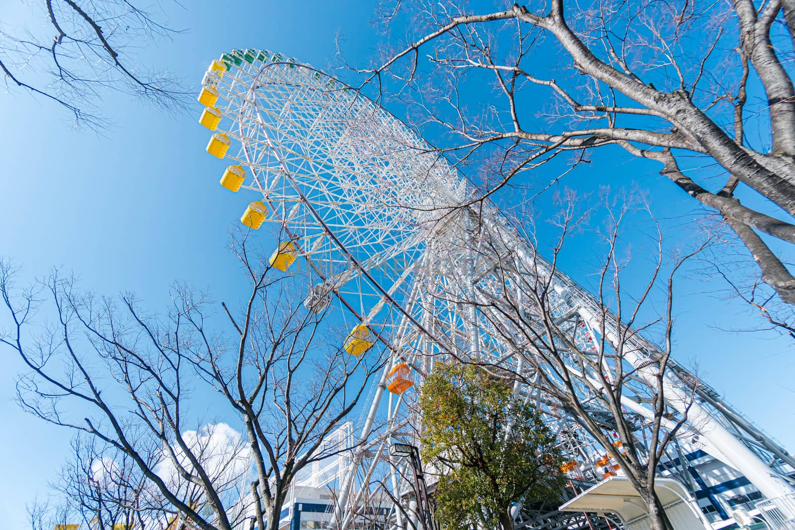 Tempozan giant ferris wheel in Osaka, Japan with  bright blue sk by Songpracone