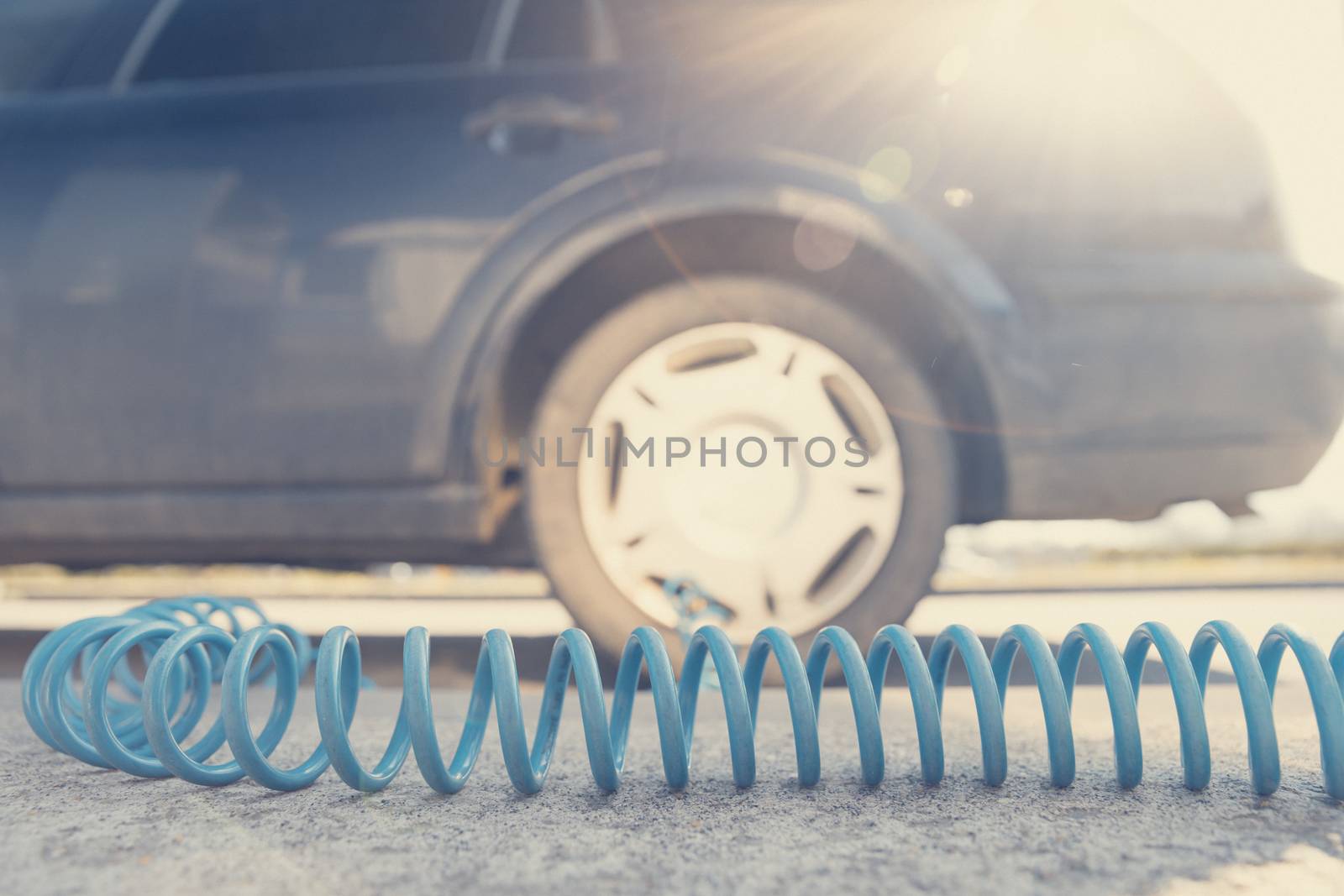 inflating the car tires with air using a compressor.