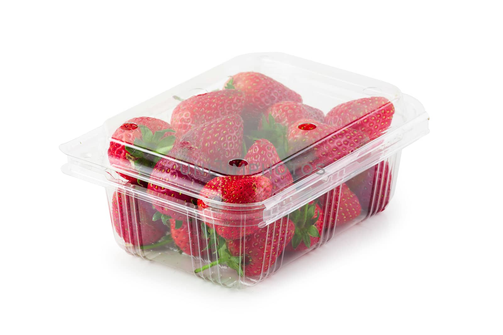 Fresh strawberries in a clear plastic box isolated on a white background.