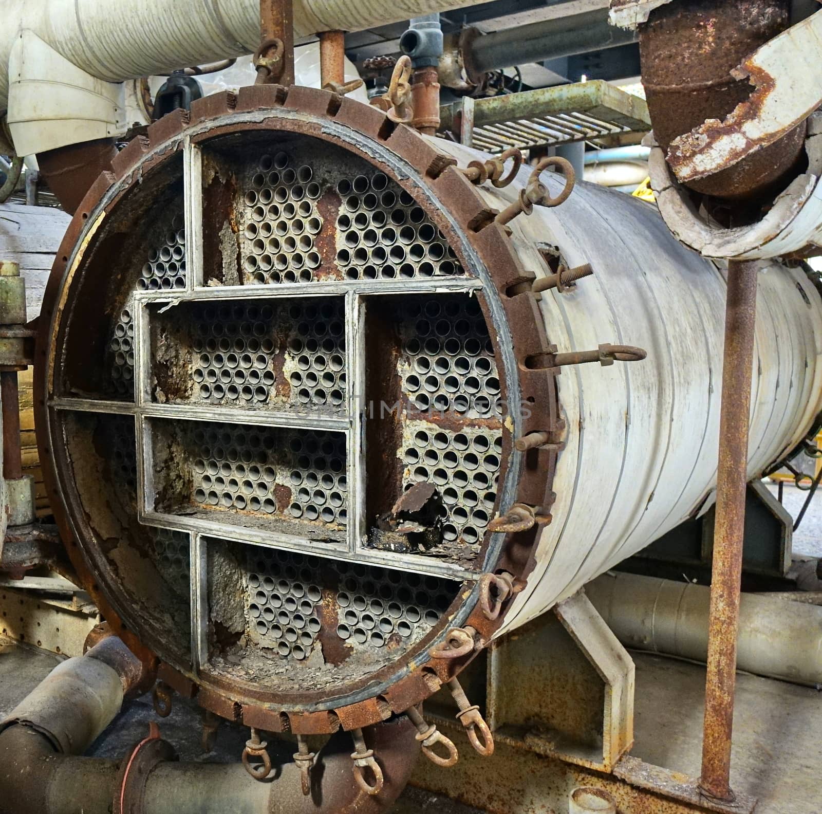 Large industrial boiler in a deserted factory building