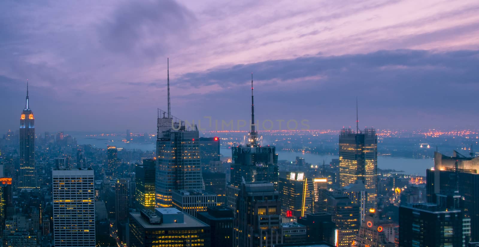 Skyline of New York City with skyscrapers at sunset