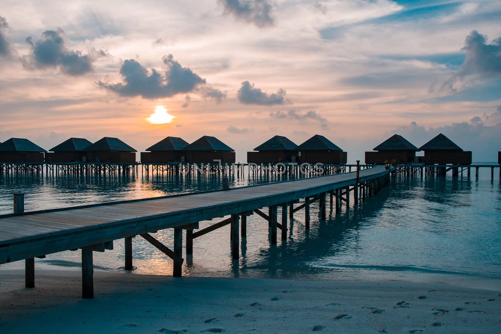 Beautiful sunset with water bungalows or water villas at Maldives