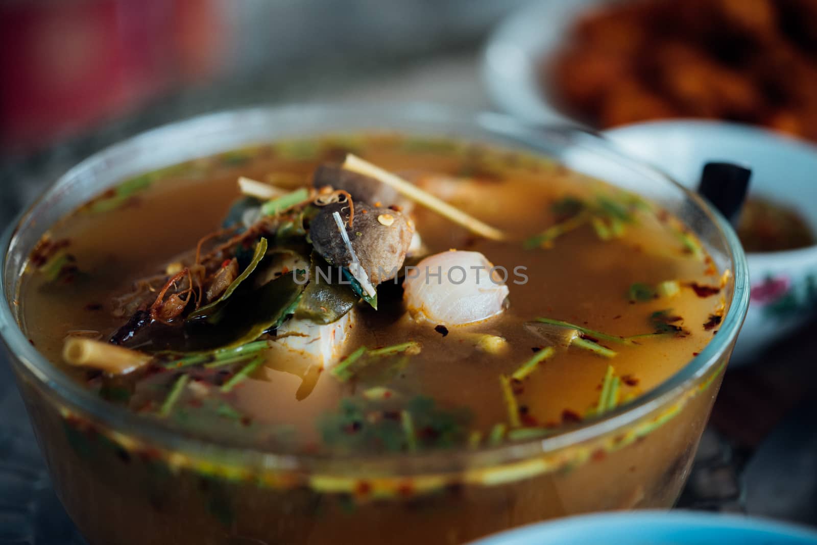 Hot and sour seafood soup (Tom Yum) for sale at Thai street food market or restaurant in Thailand