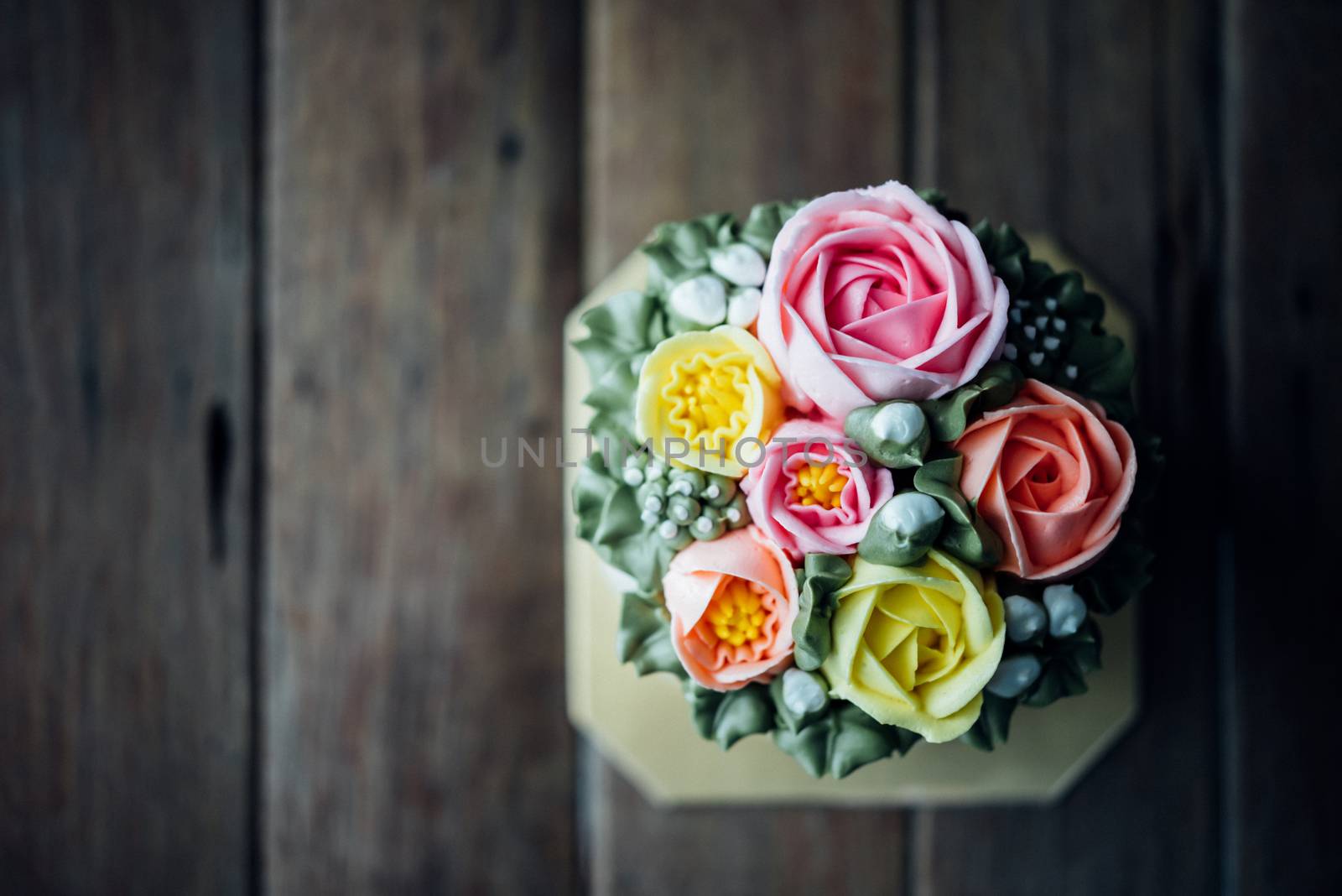 Cake cream is sweet dessert on wooden table by PongMoji