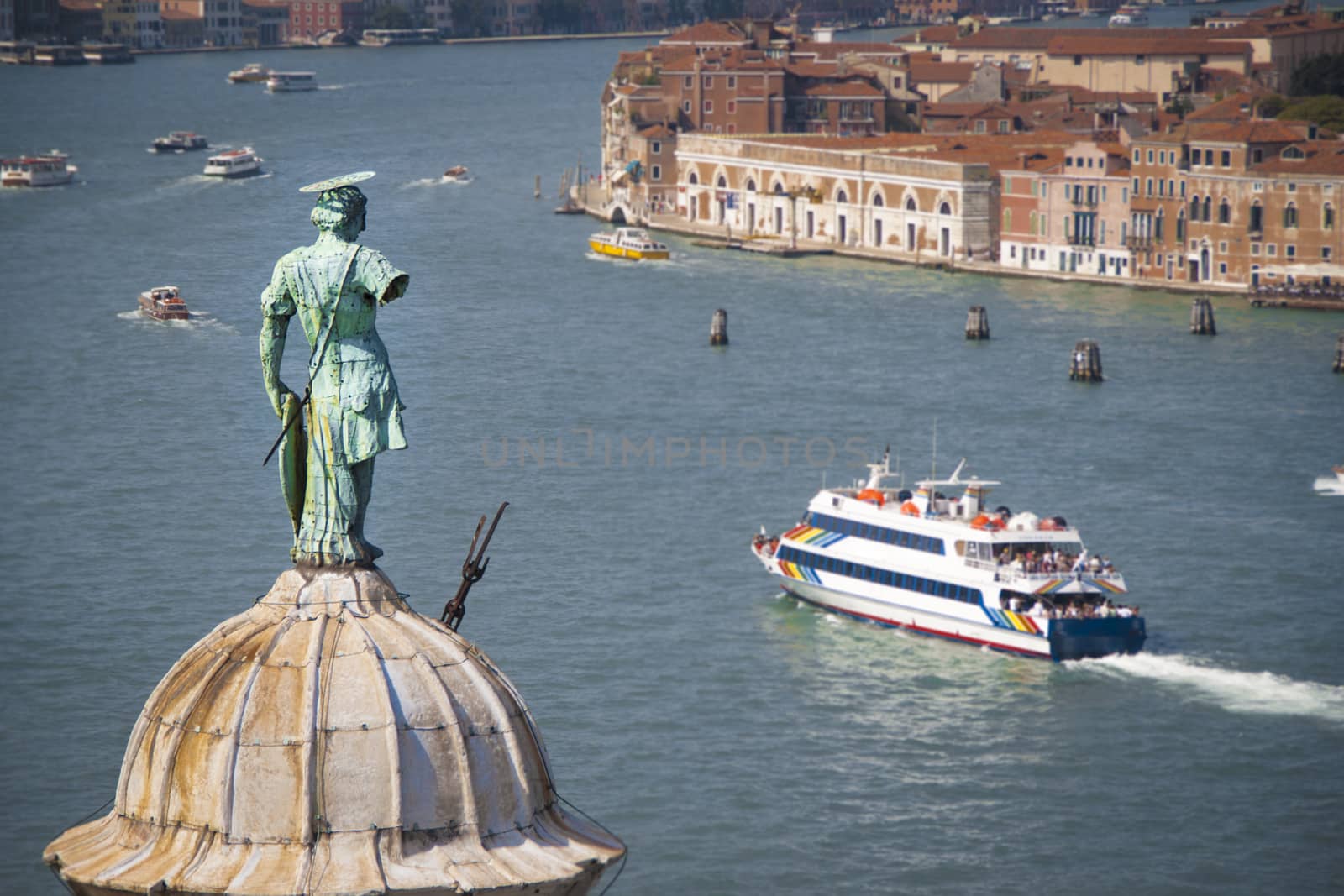 Aerial view of Venice lagoon and San Giorgio Maggiore dome with statue from the top of Campanile