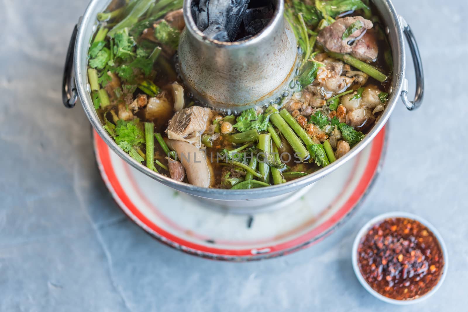 Braised beef clear with meat tendon soup stew (Ekaehla meat) with vegetable in hot pot for sale at Thai street food market or restaurant in Thailand