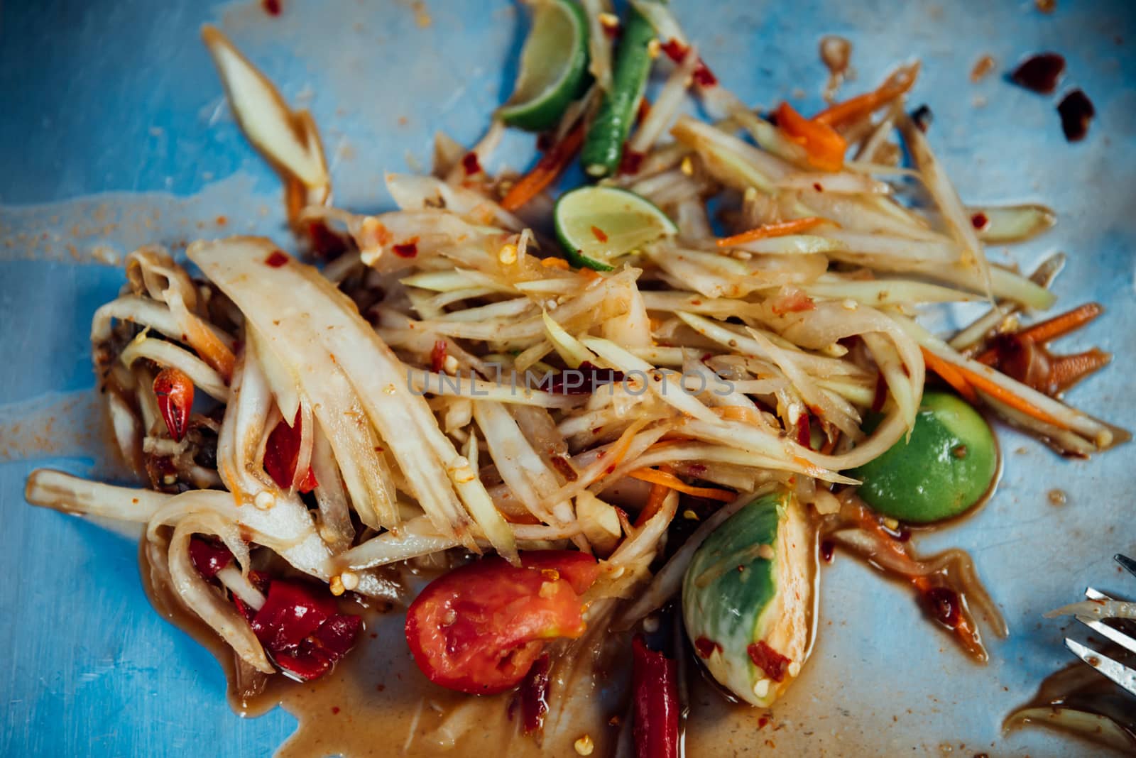 Papaya salad or Papaya Pok Pok (Som tum) for sale at Thai street food market or restaurant in Thailand