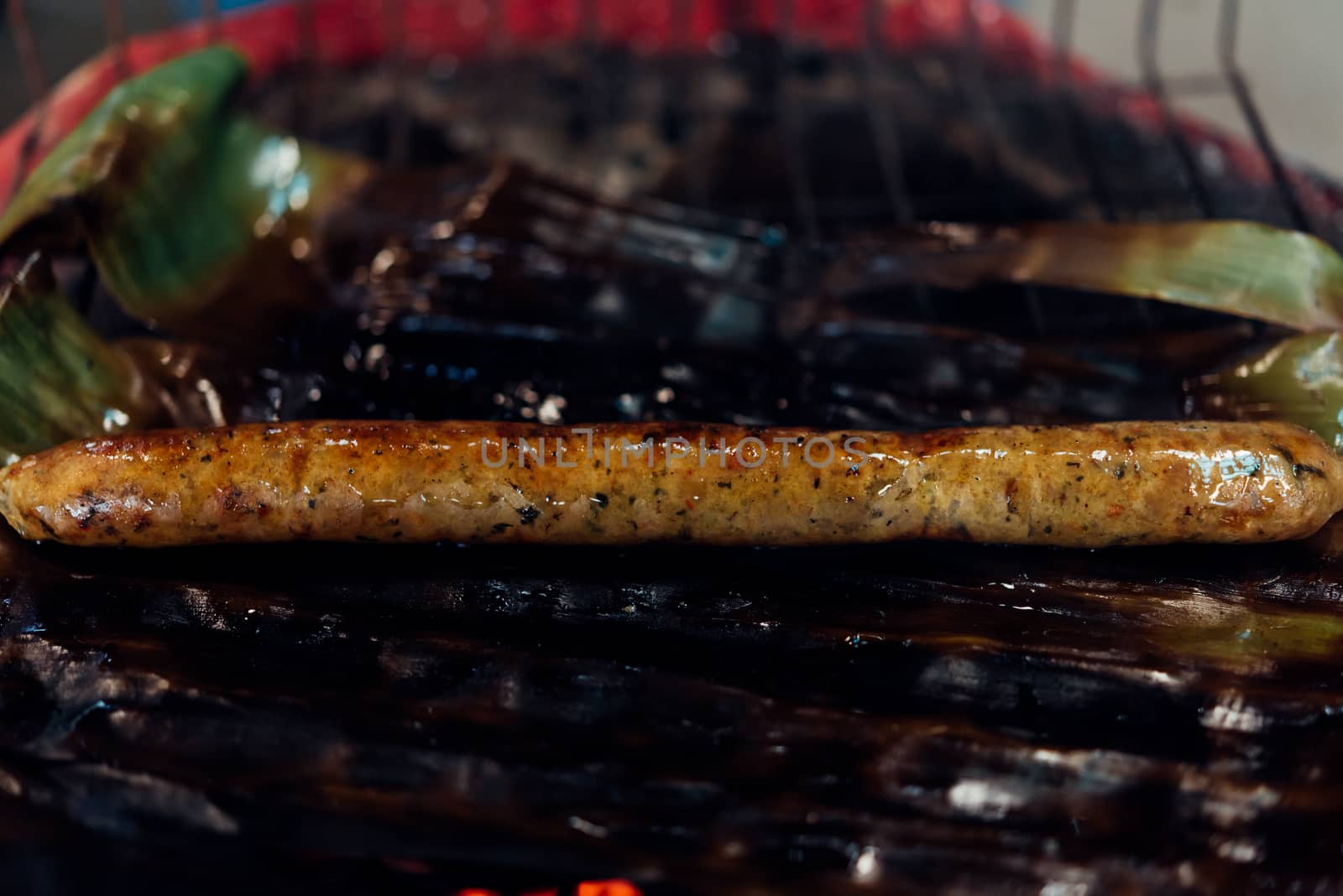 Roasted or Grilled Notrhern Thai Spicy Sausage (Sai Aua) for sale at Thai street food market or restaurant in Thailand