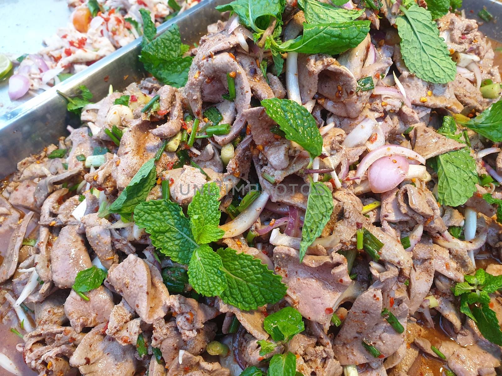 Spicy Pork Liver Salad (Tub Wan) is a Thai Esan food for sale at Thai street food market or restaurant in Thailand