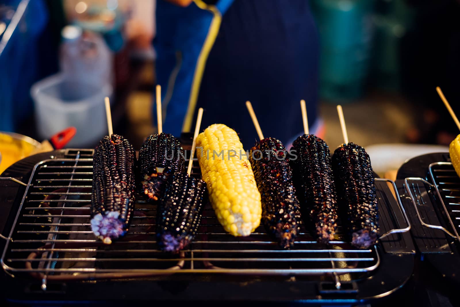 Roasted or Grilled Corn and Purple Corn (Black Glutinous Corn) for sale at Thai street food market or restaurant in Thailand