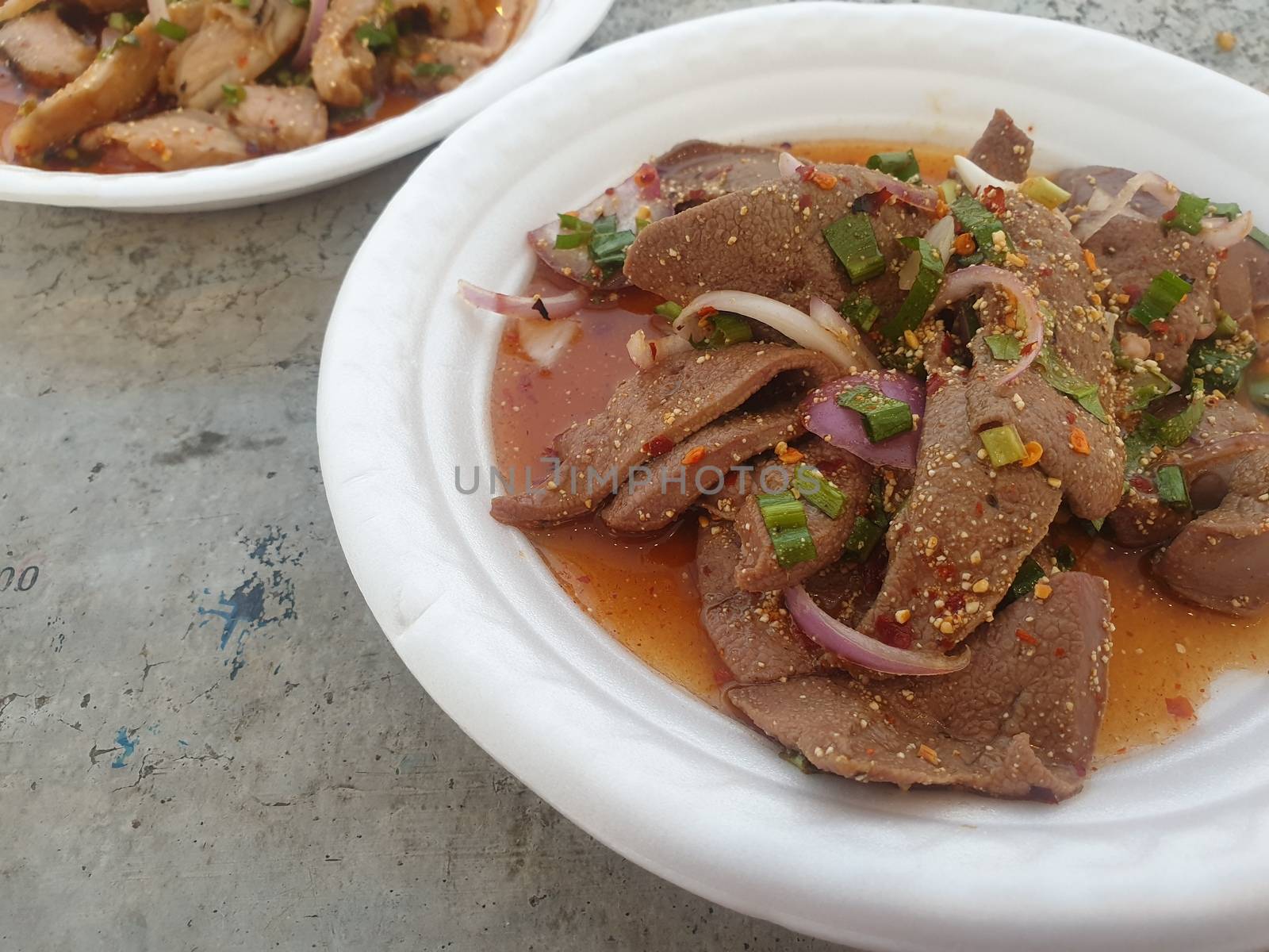 Spicy Pork Liver Salad (Tub Wan) is a Thai Esan food for sale at Thai street food market or restaurant in Thailand