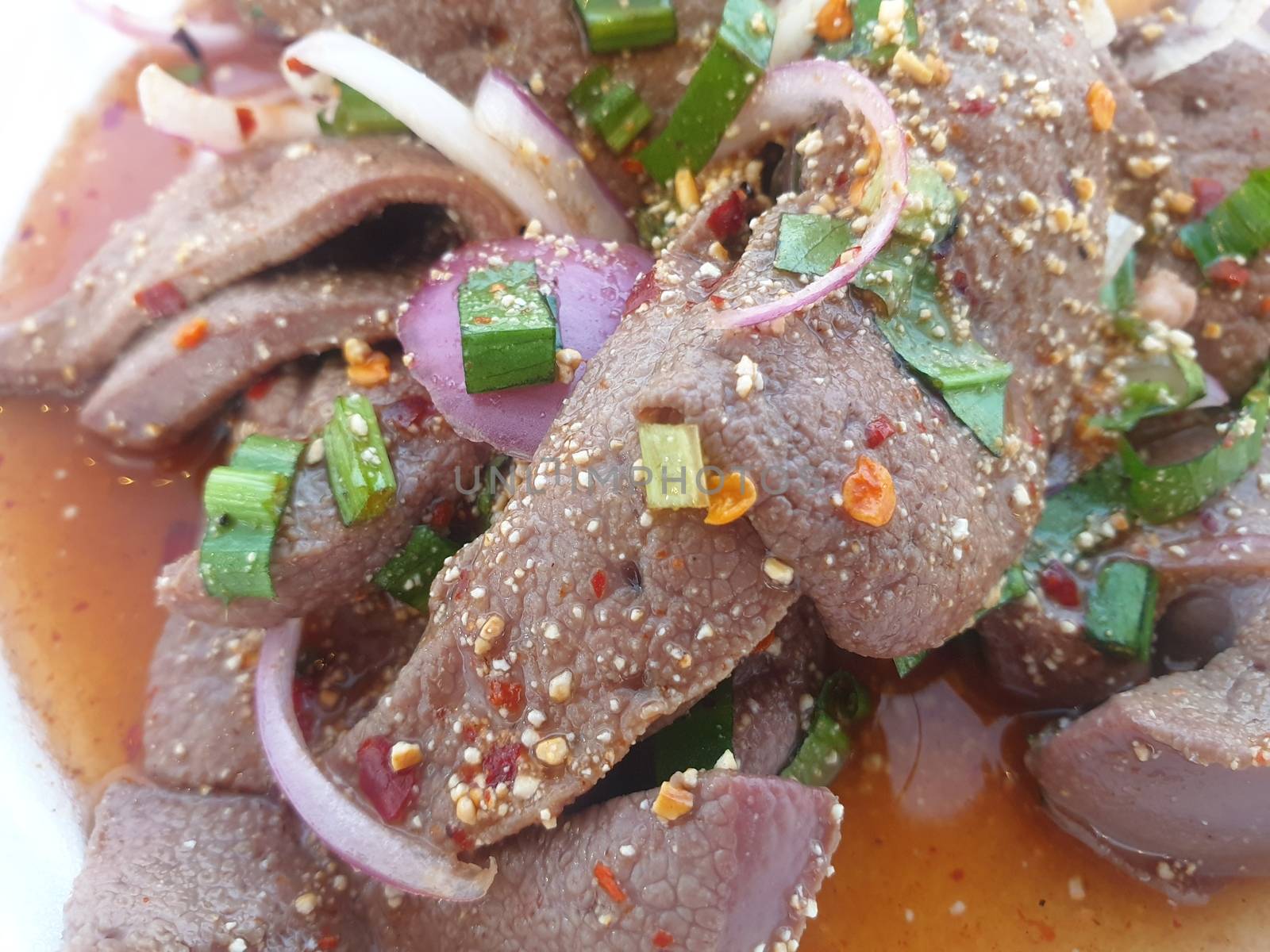 Spicy Pork Liver Salad (Tub Wan) is a Thai Esan food for sale at Thai street food market or restaurant in Thailand