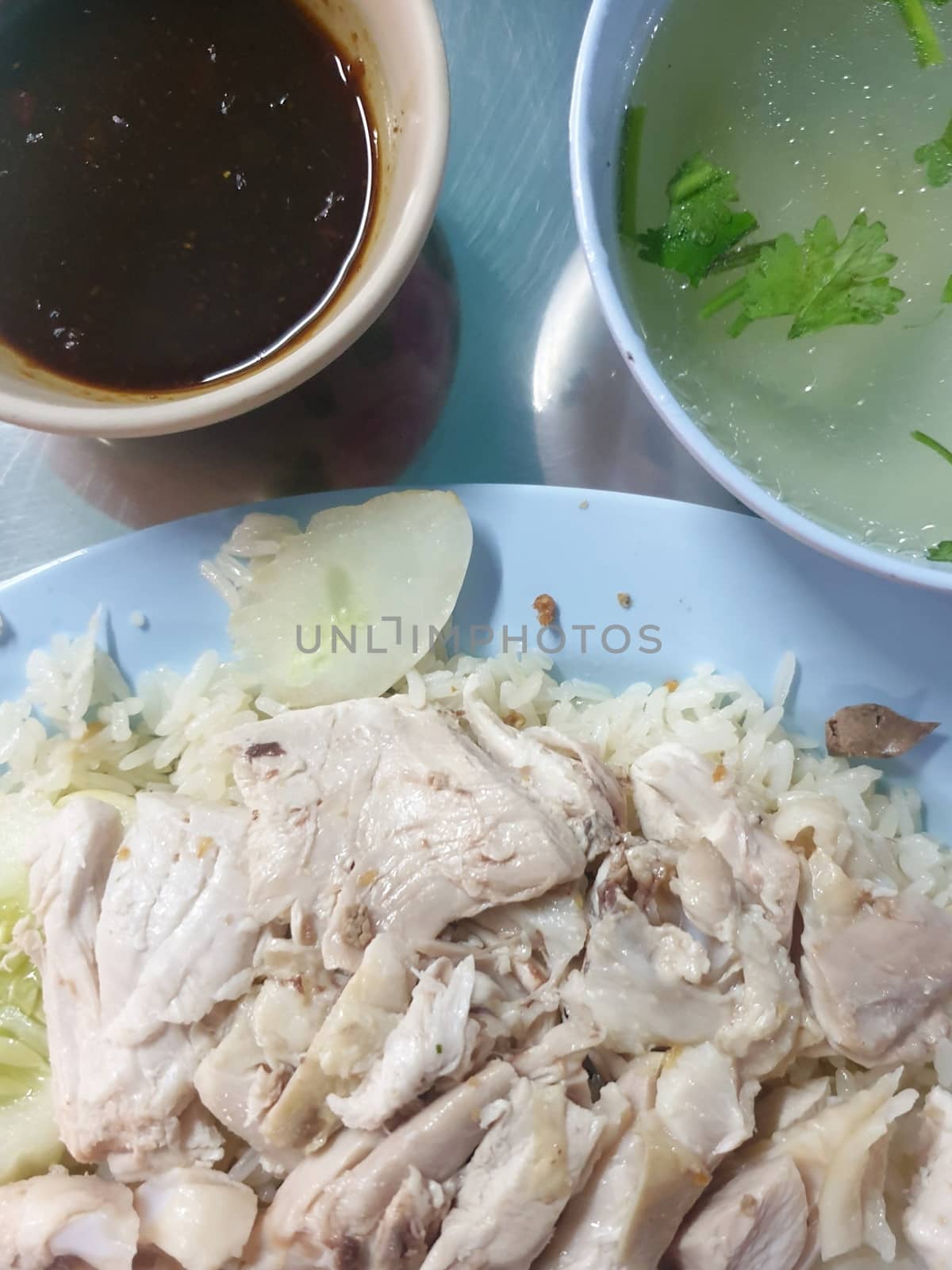 Rice steamed with chicken soup (hainanese chicken rice) for sale at Thai street food market.