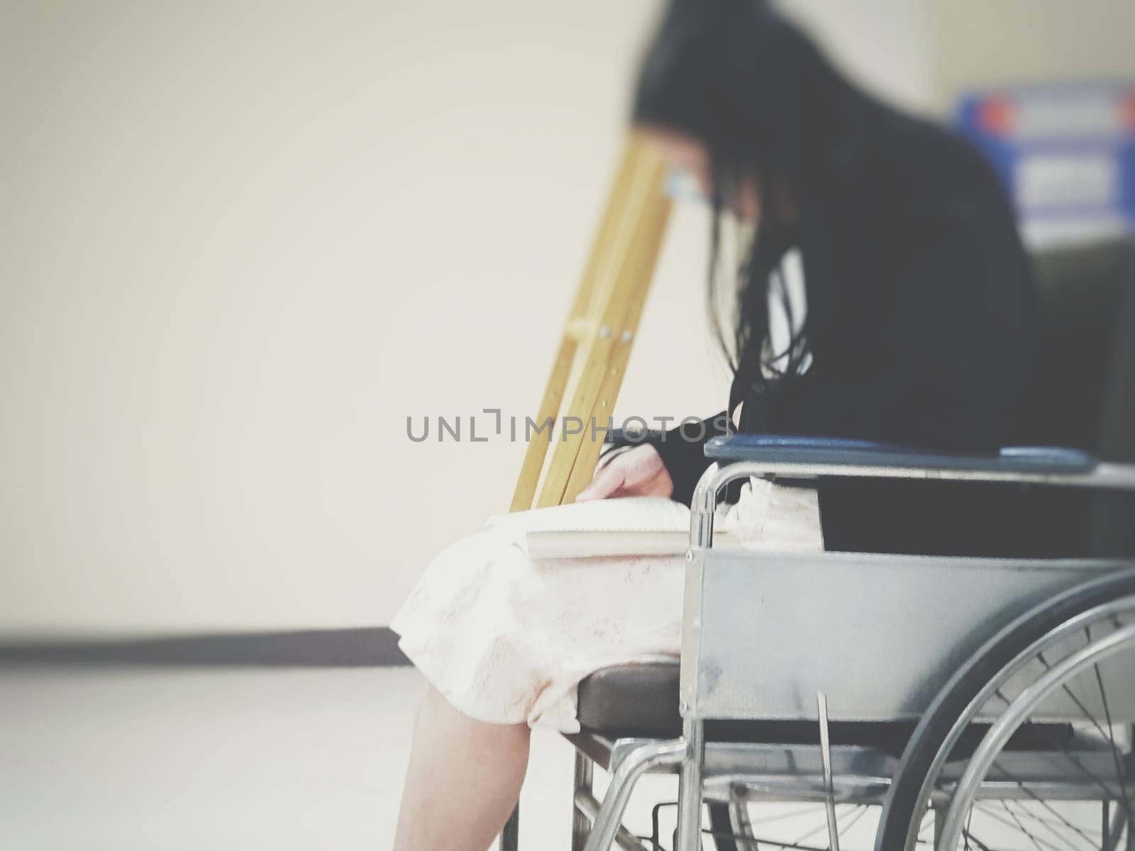 Patient on wheelchair and many patient waiting a doctor and nurse in hospital