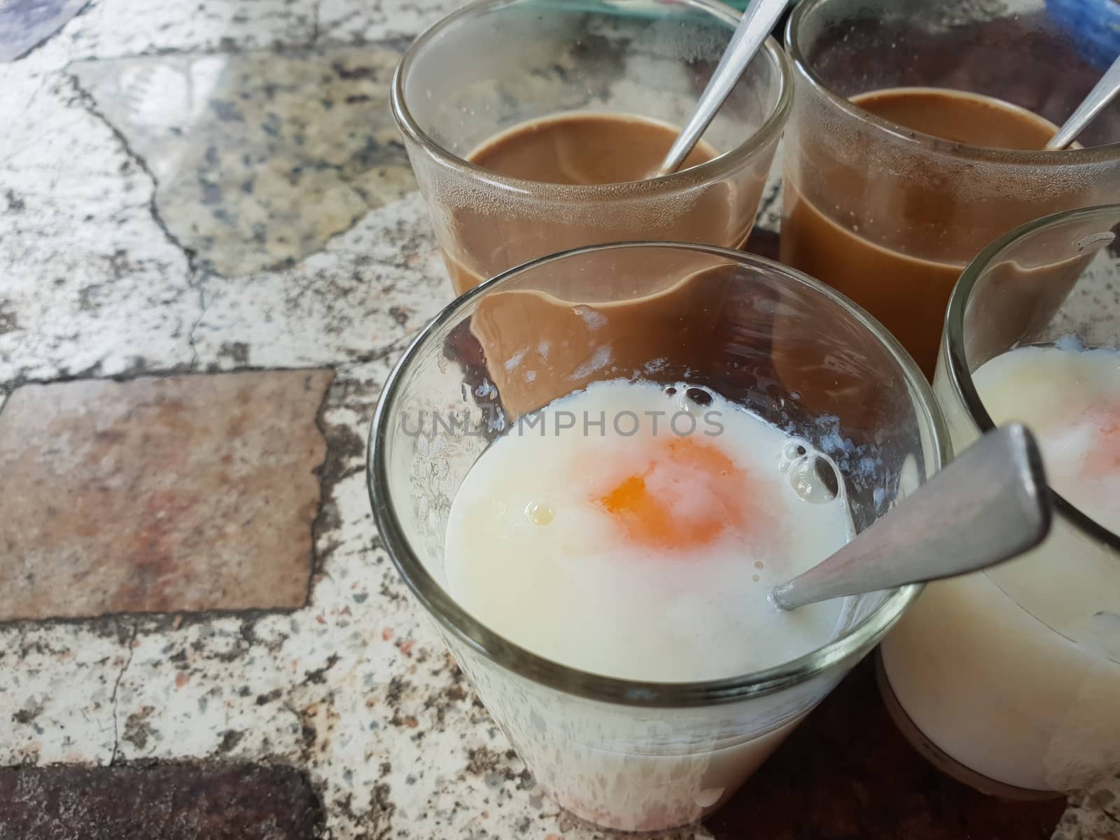 Breakfast food with soft-boiled eggs and vintage coffee Thai style for sale at Thai street food market or Thai vintage style coffee shop restaurant in Thailand