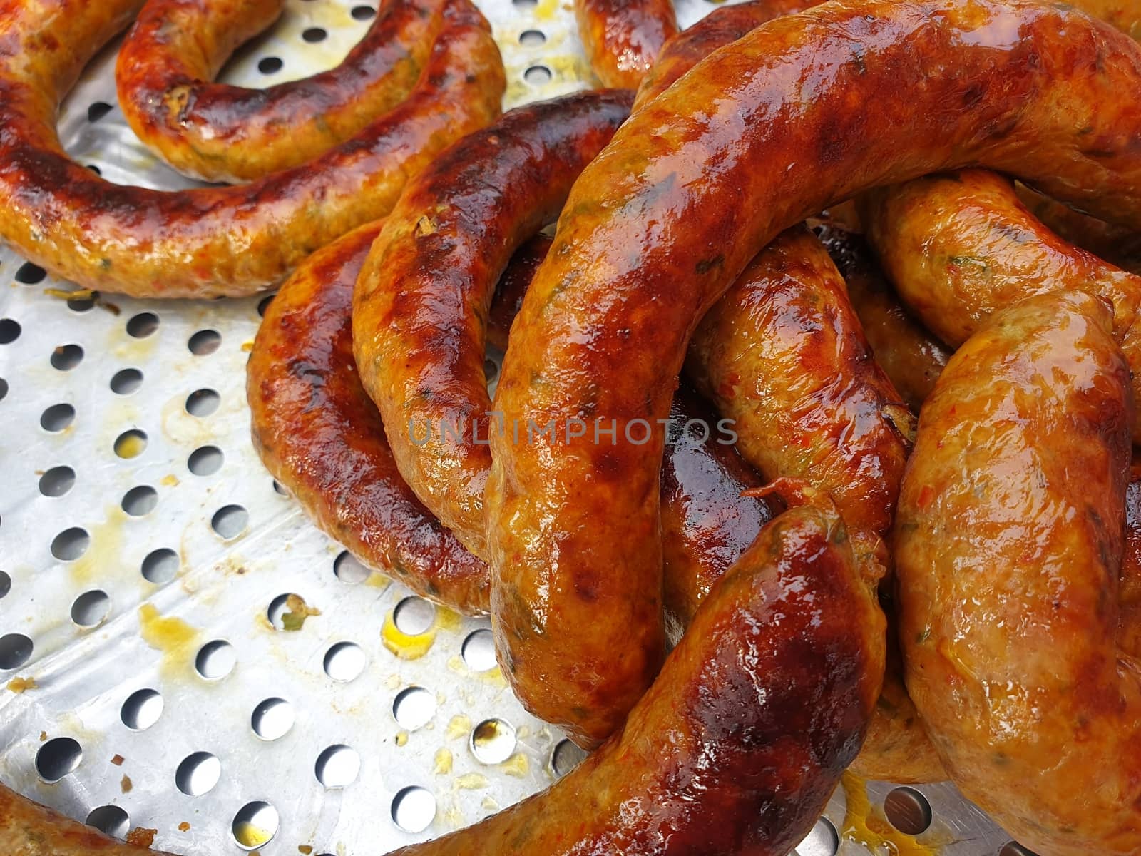 Roasted or Grilled Notrhern Thai Spicy Sausage (Sai Aua) for sale at Thai street food market or restaurant in Thailand