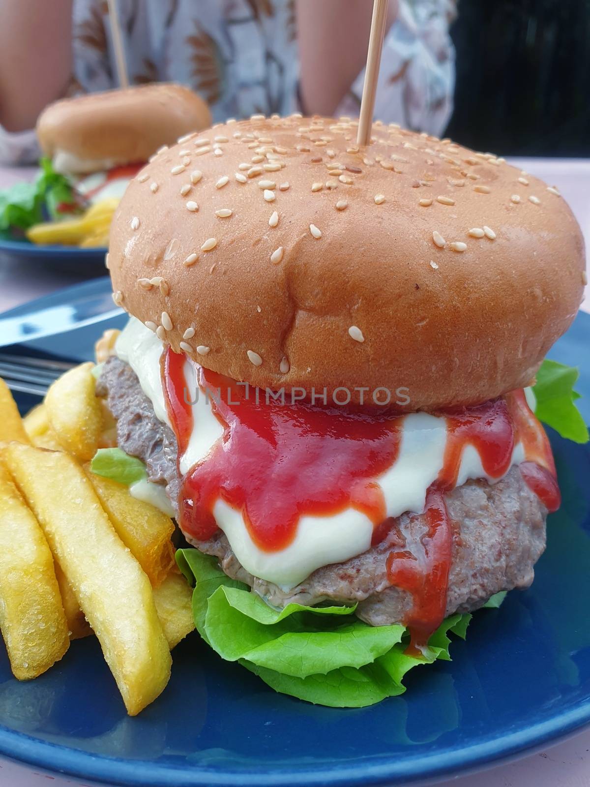 Hamburger is a fast food make from bun, meat, cheese and vegetable  in fastfood restaurant, unhealthy food or fat concept