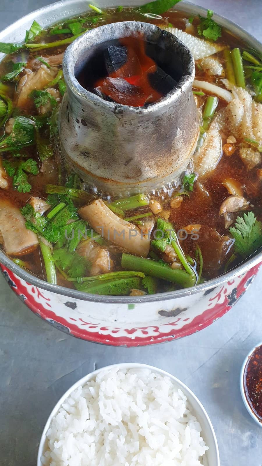 Braised beef clear with meat tendon soup stew (Ekaehla meat) with vegetable in hot pot for sale at Thai street food market or restaurant in Thailand
