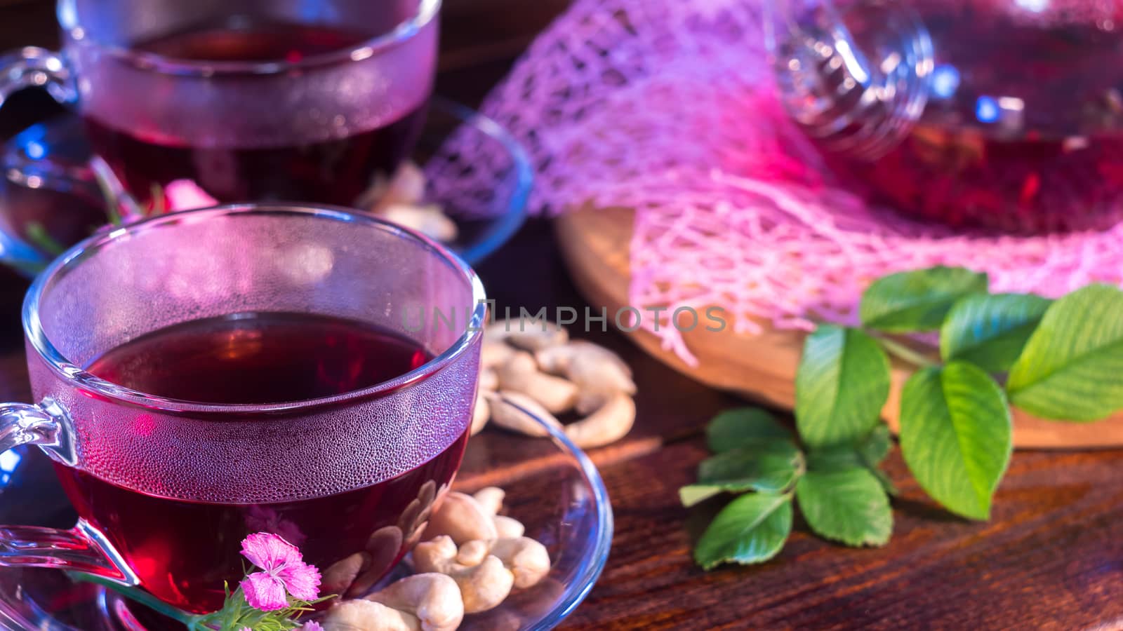 English tea. Red hot hibiscus tea in glass mug. Tea time: cup of tea, carcade, karkade, rooibos. Oriental, cozy, ceremony, tradition, japanese, leafy, hygge, autumn, 5 o'clock, afternoon