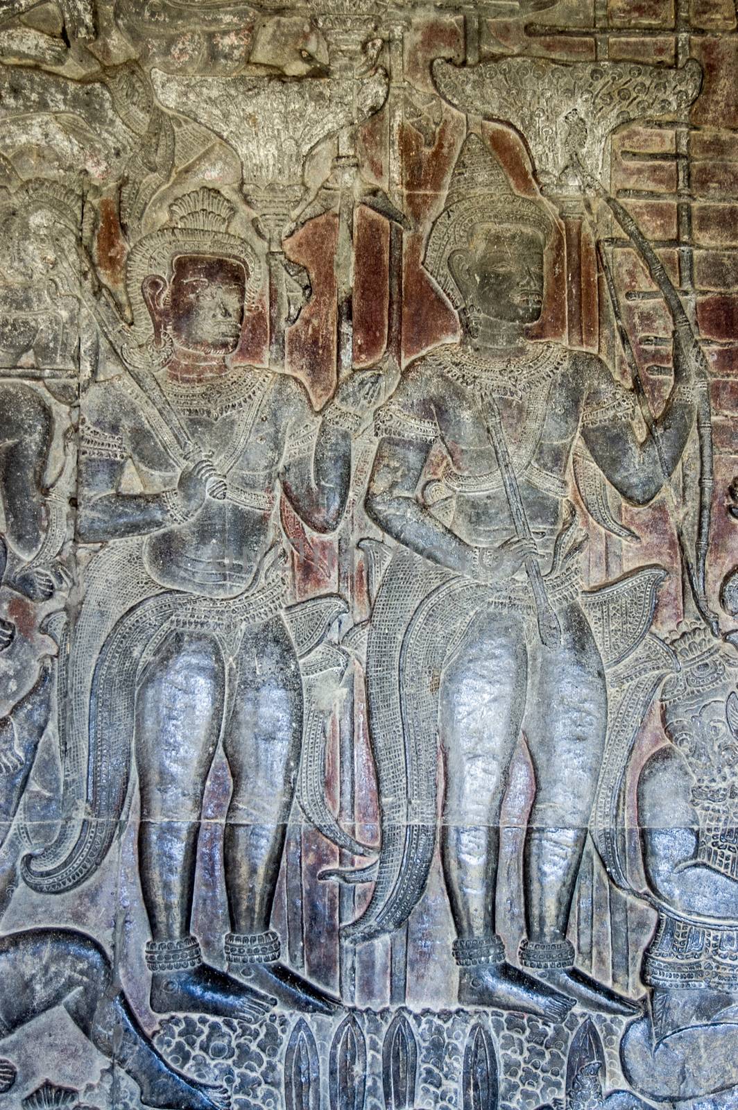 Ancient Khmer bas relief frieze of the Hindu gods Vishnu, carrying a mace and Rama with his bow and arrow. Wall of Angkor Wat temple, Siem Reap, Cambodia.