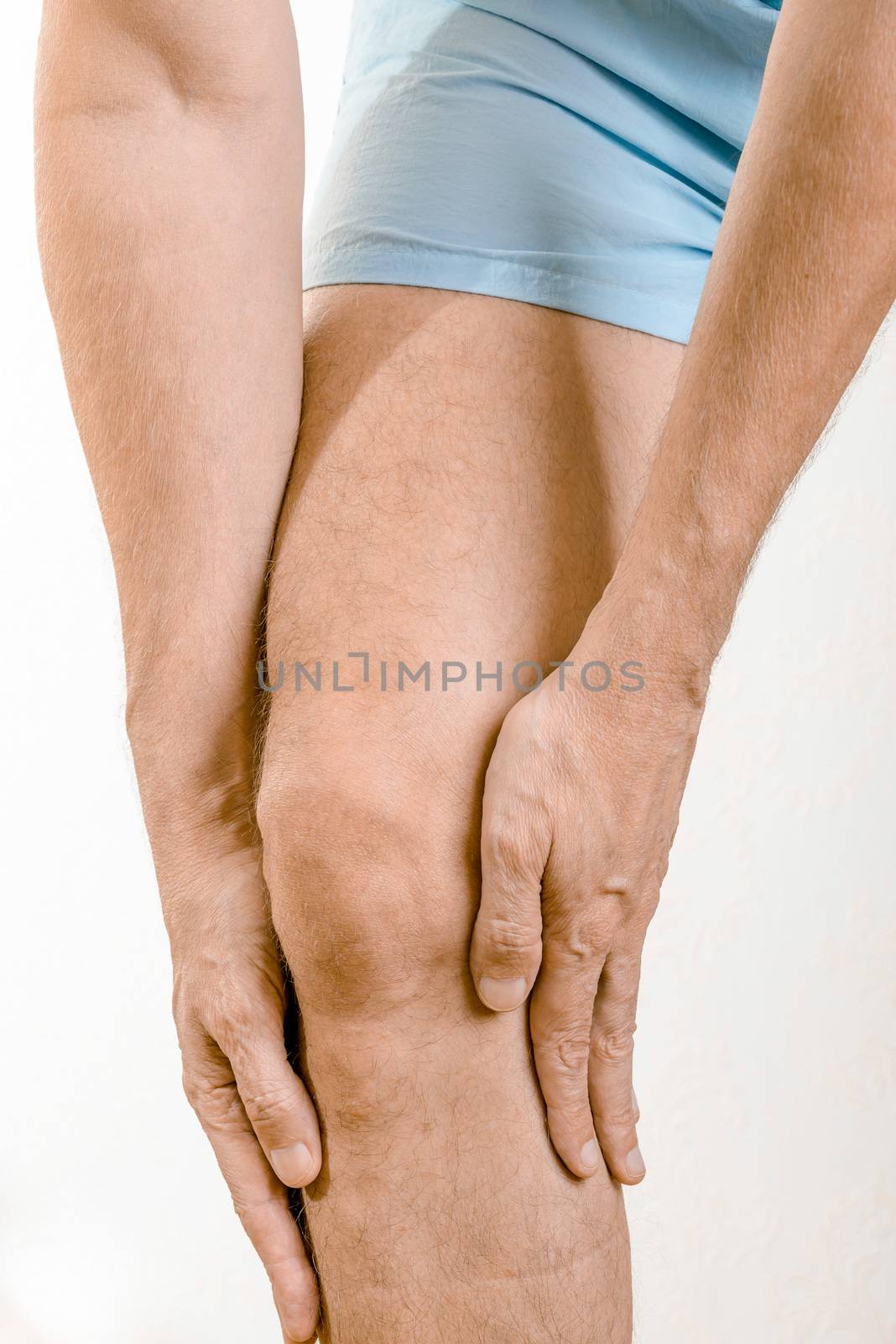 Athlete man massaging a painful  soleus and gastrocnemius muscle, under the knee, after a sport accident. It could a musculaire claquage or a muscle elongation