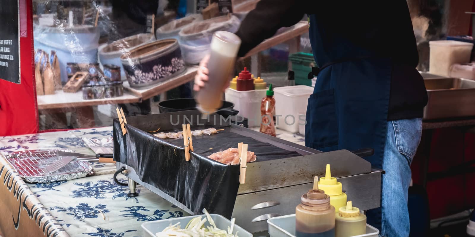 Live food stall where a cook prepares a meal in front of his cli by AtlanticEUROSTOXX