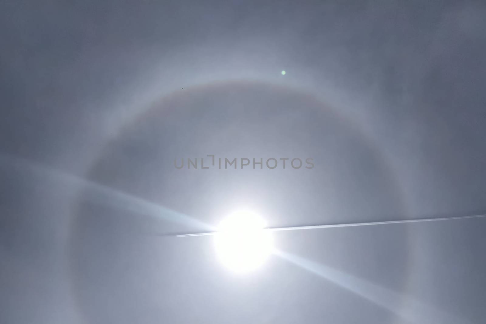 The phenomenon of halo in the sky. A rare natural phenomenon. Three halo suns. The plane flies through the halo.