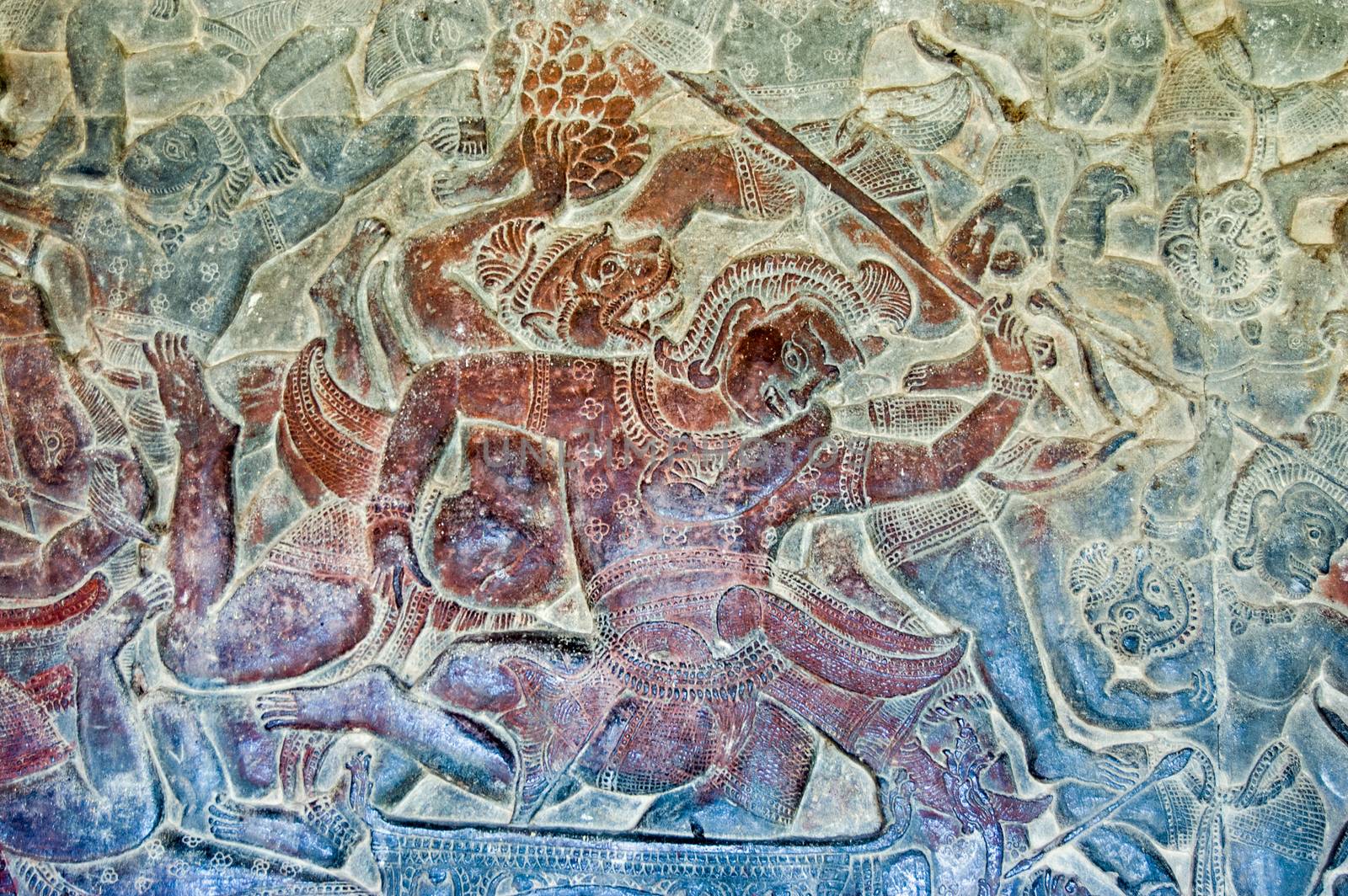 Bas relief showing a scene from the Battle of Lanka between Rama and Ravana as described in the epic Ramayana. A monkey soldier is fighting a demon. Wall of Angkor Wat Temple, Angkor, Cambodia.