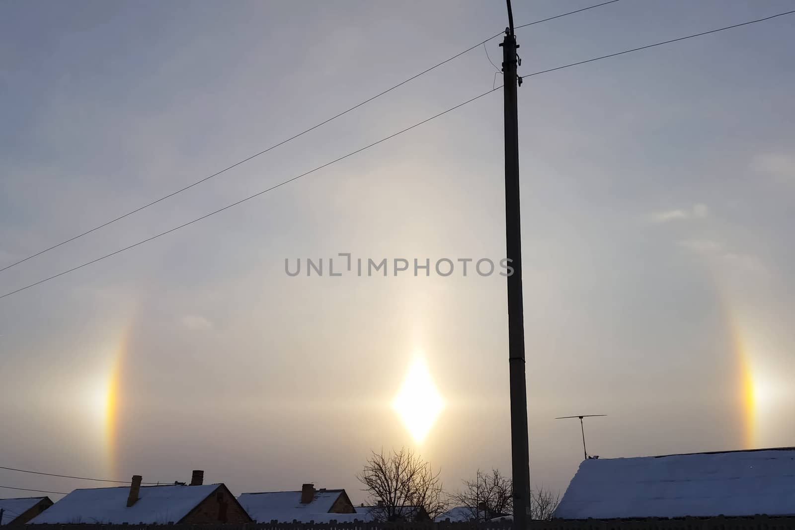 The phenomenon of halo in the sky. A rare natural phenomenon. Three halo suns.