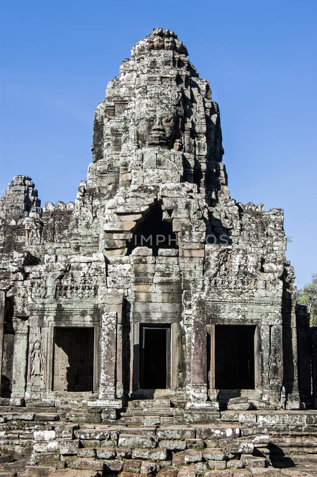 Part of the magnificent Bayon Temple at Angkor Thom, Cambodia. Detail shows one of the towers topped with a carved face.