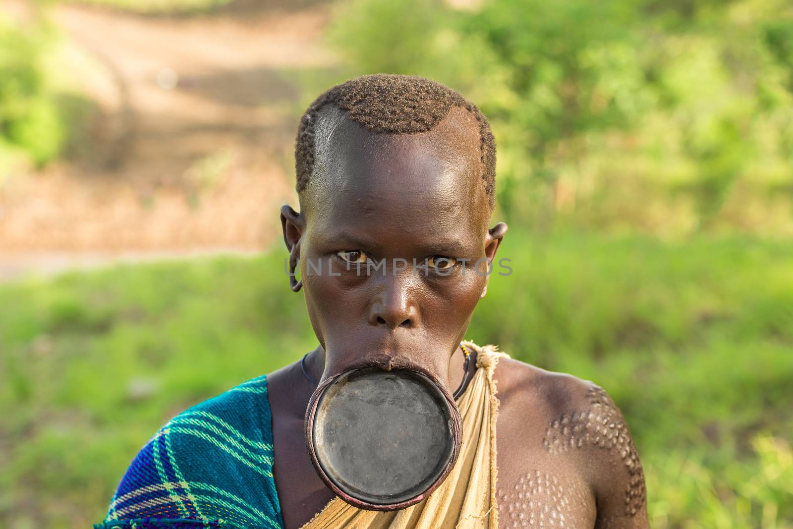 OMO VALLEY, ETHIOPIA - MAY 3, 2015 : Woman from the African tribe Surma with big lip plate.