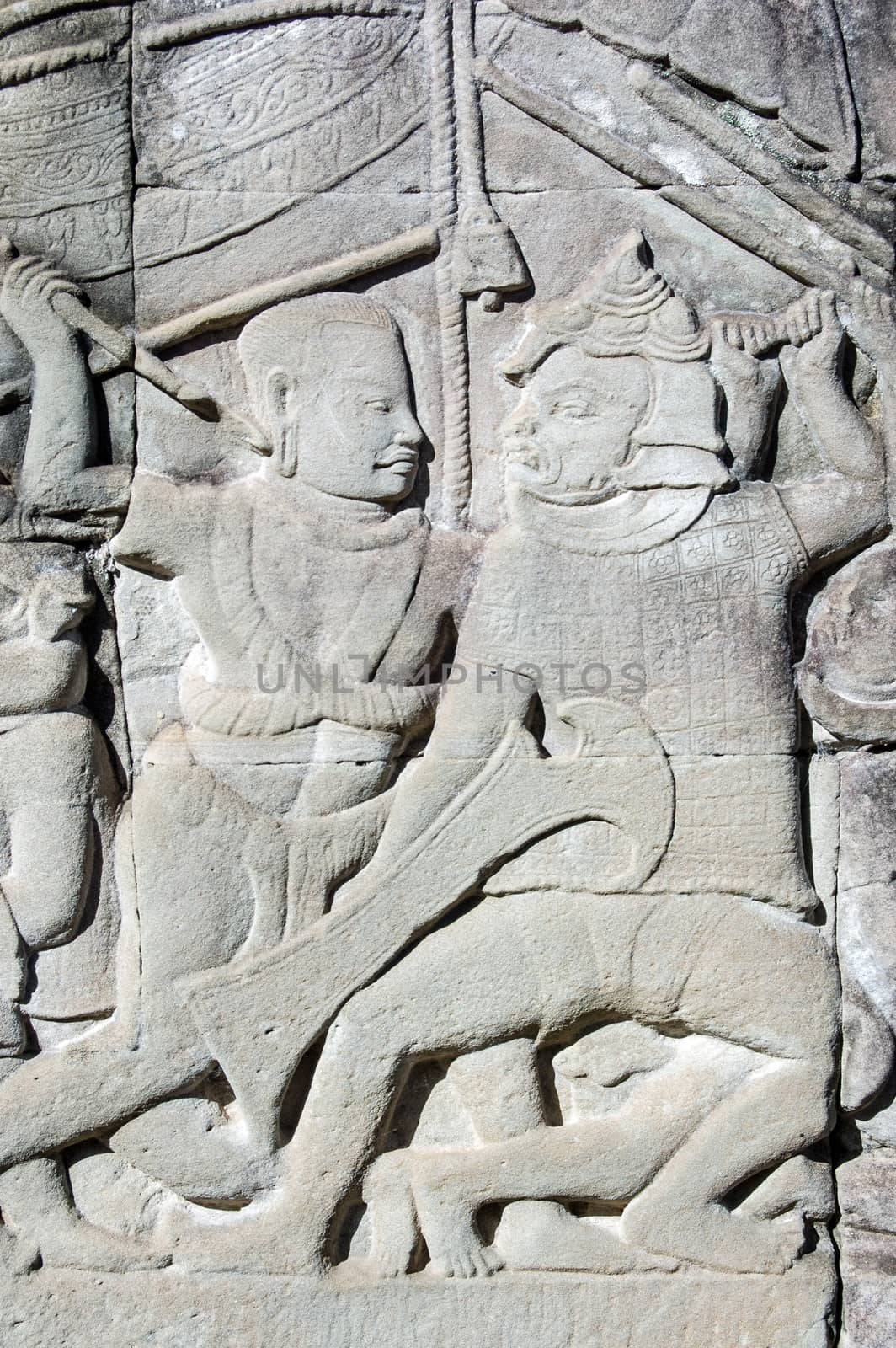 Ancient bas relief carving showing a Khmer and a Cham soldier fighting. Wall of Bayon Temple, Angkor Thom, Siem Reap, Cambodia.