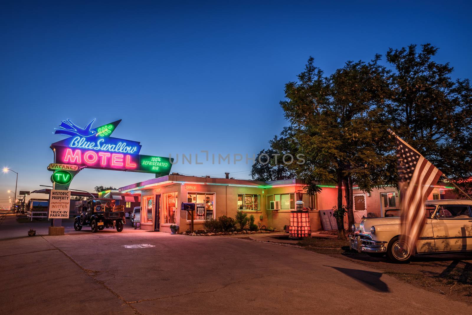 TUCUMCARI, NEW MEXICO - MAY 13, 2016 : Historic Blue Swallow Motel with vintage cars parked in front of it. This building is listed on the National Register of Historic Places in New Mexico.