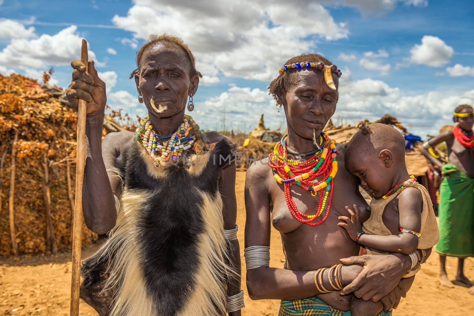 OMO VALLEY, ETHIOPIA - MAY 6, 2015 : Tribal chief, his wife and her baby from the African tribe Dasanesh in their village.