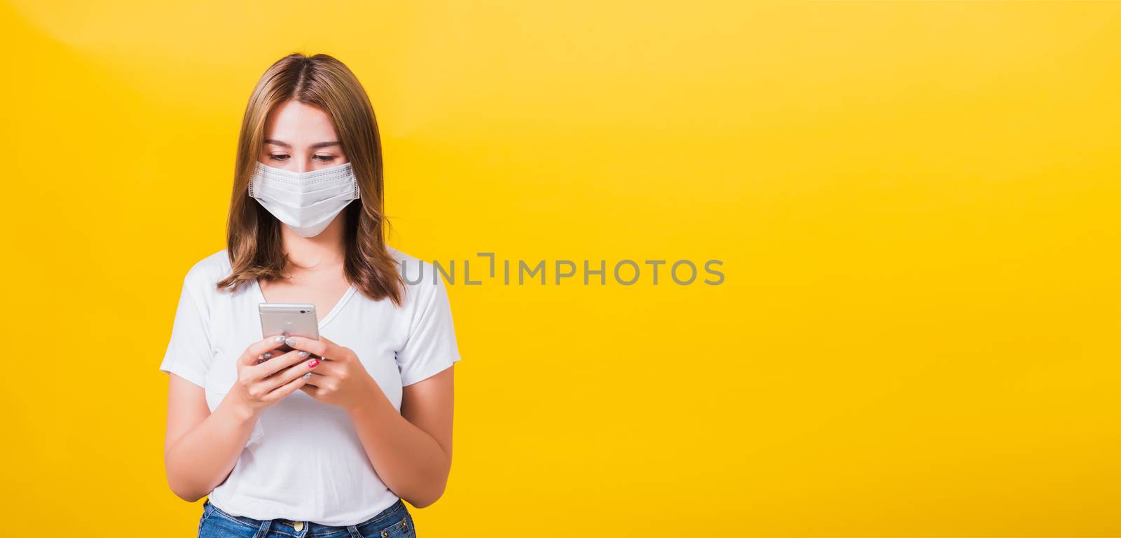 woman wearing mask protection, reading news update on smartphone by Sorapop